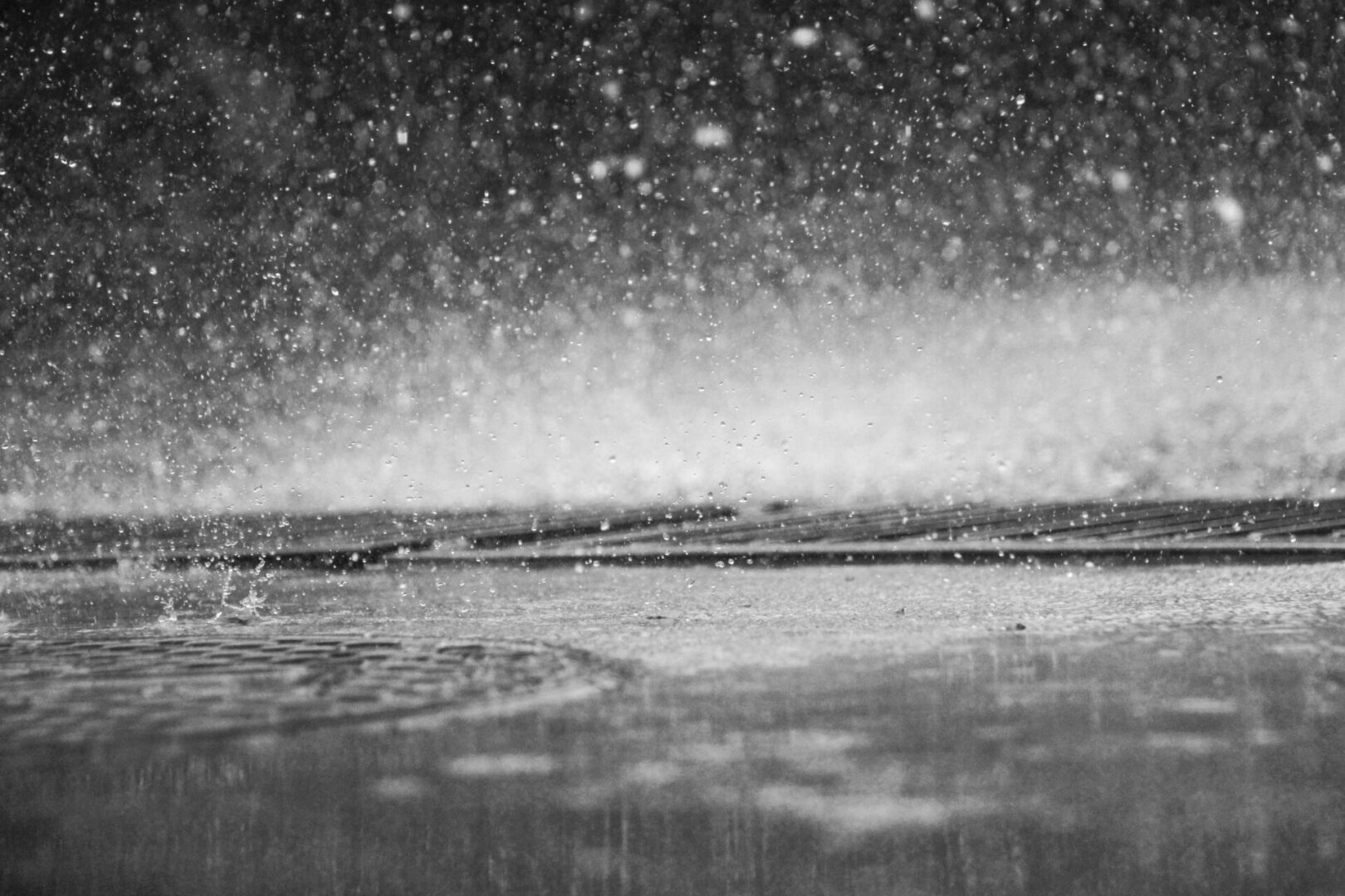 A black and white photo of the sky in the rain.